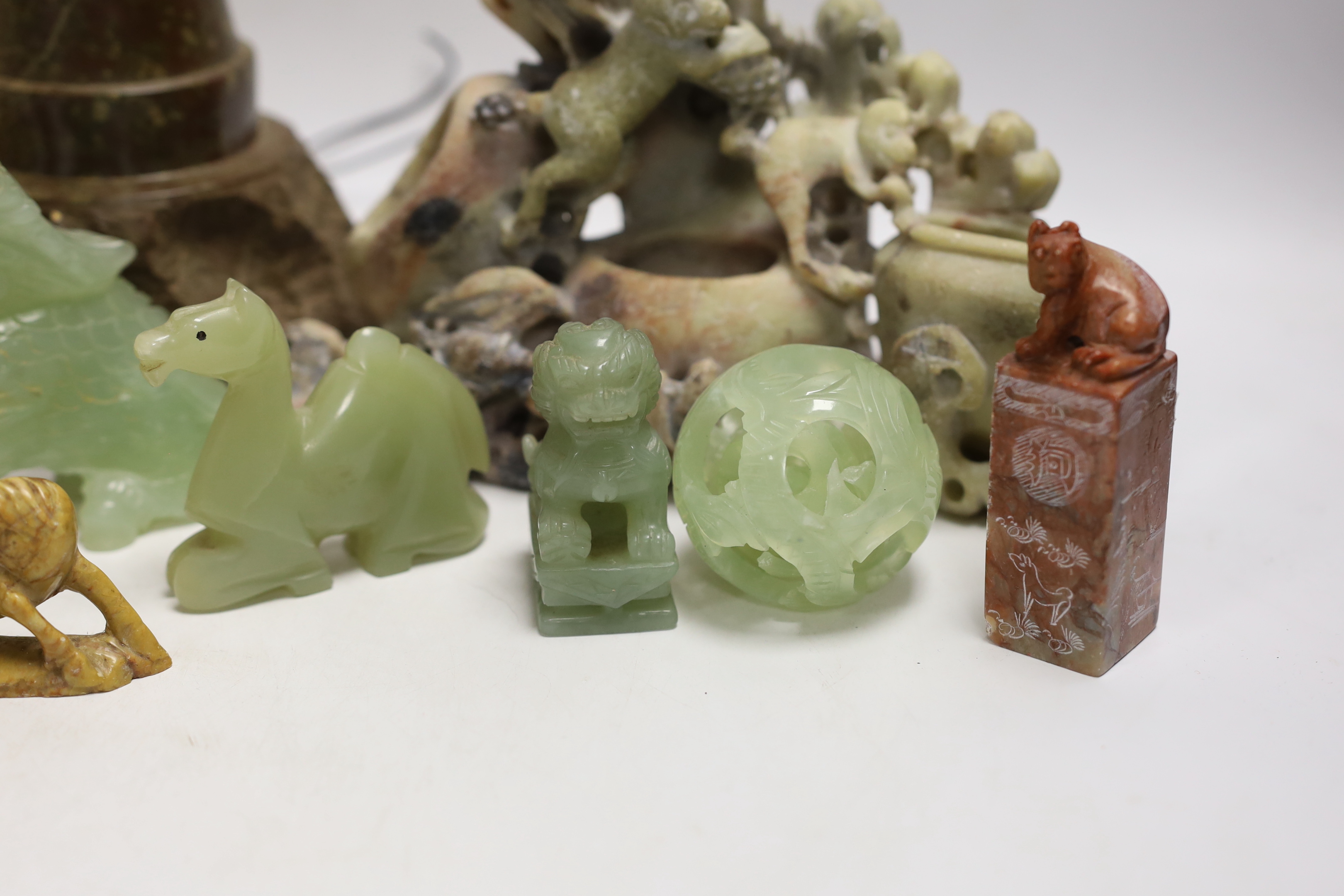 A Cornish serpentine novelty lighthouse lamp and mixed soapstone and hard stone carvings (12), lamp 25cm high